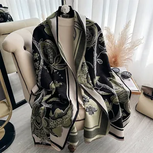 Knitted shawl with pomegranate floral jacquard pattern and fringe trim in black and green