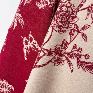 Detail of vintage floral pattern on thick faux cashmere scarf in red and beige tones