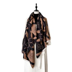 Geometric cashmere-feel scarf in black and camel color block with floral patterns