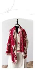 Close-up of faux cashmere shawl with vintage swallow patterns and fringe edges
