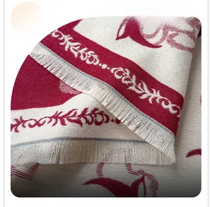 Detailed close-up of red and white jacquard tassel fringe on a warm winter scarf