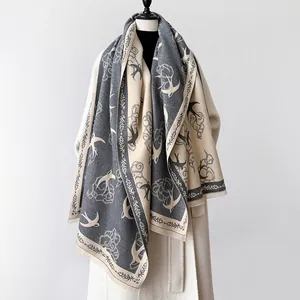 Detailed close-up of cashmere-like shawl with swallow bird and cloud jacquard weaving