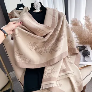 Elegant cashmere-like shawl featuring bamboo leaf print and fringe in beige and camel tones