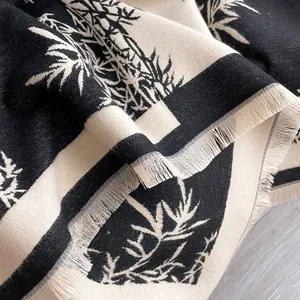 Cashmere blend scarf featuring black and white bamboo prints with elegant fringe edges