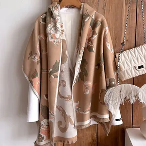 Detail of vintage floral knit shawl with fringes and soft camel cashmere feel