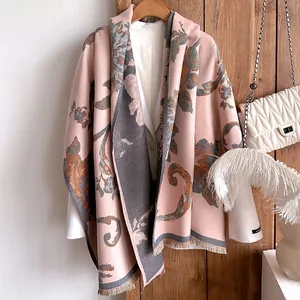 Detail of floral print shawl with pink and grey contrast colors and fringe trim