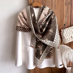 Detail of vintage cashmere-like scarf with floral print, dots and tassel fringe