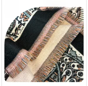 Macro shot of ethnic pattern shawl showing bohemian fringe and woven cashmere texture
