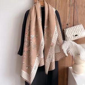 Detail of vintage floral print scarf with soft cashmere-like texture and tassel edges