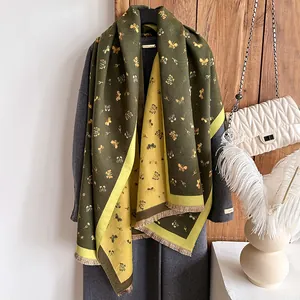 Detailed view of reversible contrast scarf with vintage butterfly patterns and fringe