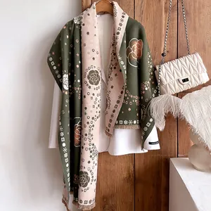 Detail of pashmina scarf featuring camellia floral patterns and delicate short fringes