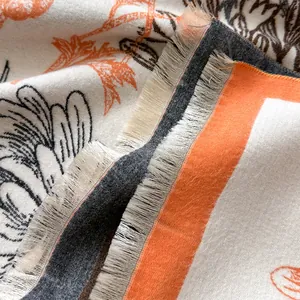 Detail of botanical print scarf showing soft cashmere-like texture and frayed tassel edges