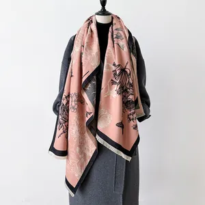 Pink cashmere-feel scarf with vintage floral sketches and fringed edges on a mannequin