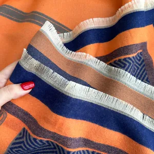 Thick cashmere-feel geometric scarf with orange and navy tassels and fringe trim