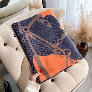 Detail of premium orange and navy scarf with equestrian motif and silk texture