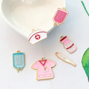 Detailed close-up of nurse themed enamel alloy pendants with medical symbols on white ceramic