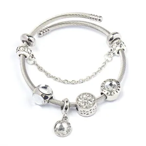 Silver twisted wire bracelet with Love Is Forever beads and crystals on white background