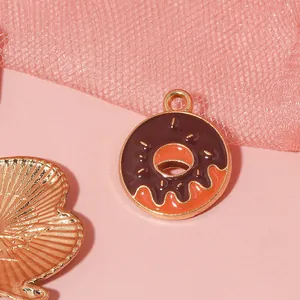 Macro shot of a chocolate and orange enamel donut pendant charm for DIY jewelry making