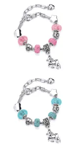 Detail view of unicorn charm bracelets featuring pink and teal beads with star pendants