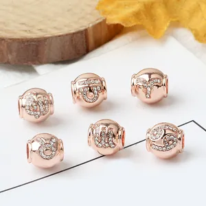 Detailed view of rose gold zodiac charms with sparkling pavé crystals for bracelets