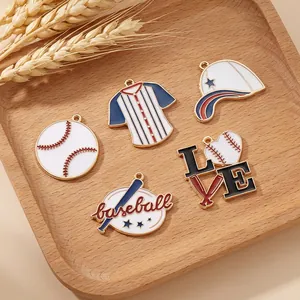 Dettaglio del set di ciondoli da baseball in smalto colorato su vassoio in legno per DIY