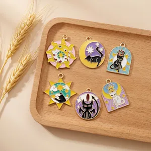 Macro shot of 6 tarot cat enamel alloy charms displayed on a wooden tray for DIY jewelry