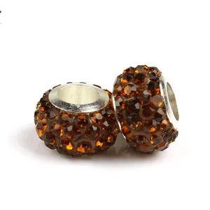 Primer plano de abalorios pavé de cristal ámbar con núcleo de metal plateado de gran agujero