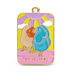 Enamel Lovers Tarot card charm featuring two colorful birds in a gold metal frame