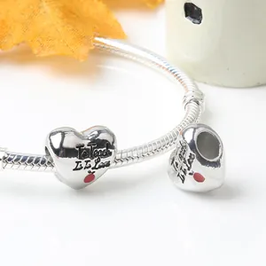 Silver heart charm with To Teach is to Love engraving and red apple on a snake chain