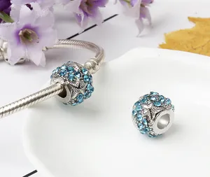 Detailed view of a blue starfish charm with rhinestones on a snake chain bracelet