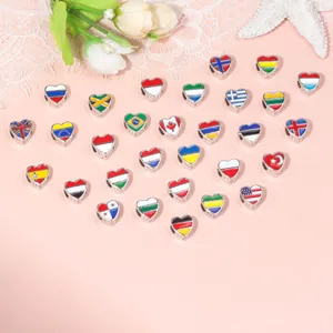 Flat lay of heart-shaped national flag beads in silver alloy for DIY jewelry making