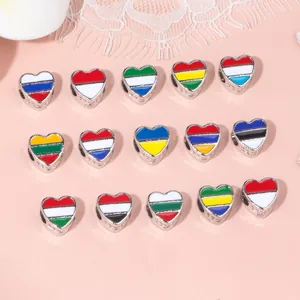 Detailed view of fifteen heart-shaped alloy national flag charms for DIY jewelry making
