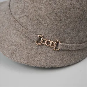Macro shot of French vintage wool equestrian hat with elegant gold chain link detail
