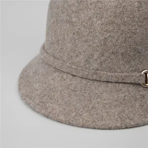 Close-up of taupe wool felt equestrian hat with a decorative gold metal ring detail