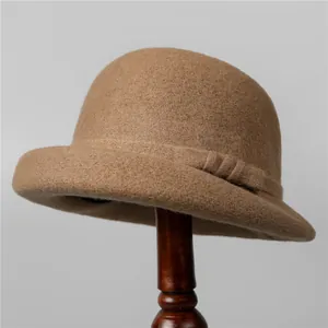 Classic dark brown wool felt cloche hat for women with elegant side ribbon on a vintage stand