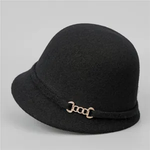Detail view of black wool felt French retro equestrian hat with gold chain buckle accent