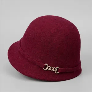 Detail of burgundy wool felt equestrian hat featuring a side gold metal chain link