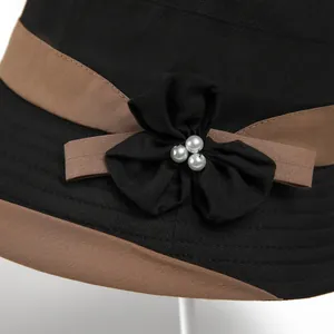Elegant black sun hat for women with brown ribbon and pearl flower detail
