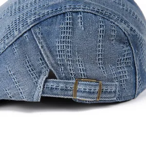Detail of vintage denim cap showing washed blue fabric and premium metal buckle closure