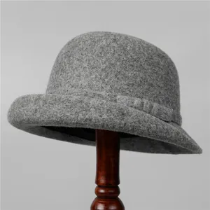 Detailed close-up of premium grey wool felt cloche hat with stylish rolled brim design