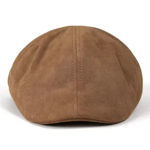 Detailed view of brown suede texture and double stitching on retro flat cap