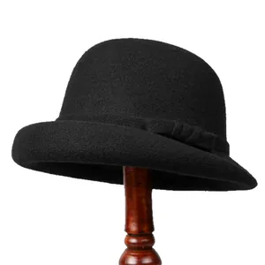 Elegant black wool felt bowler hat for women featuring a vintage round top and bow detail
