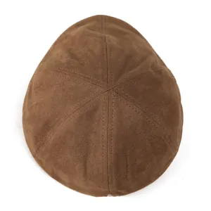 Macro view of the six-panel stitched crown and suede texture on this brown beret