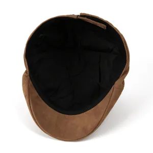 Detailed interior of brown suede newsboy cap featuring black lining and fashion label