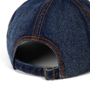 Retro denim newsboy cap with contrasting orange stitching and adjustable metal buckle