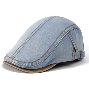 Detail of vintage denim cap showing blue washed fabric with contrasting brown brim