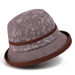 Detail view of purple vintage cloche hat with leaf pattern and brown ribbon trim