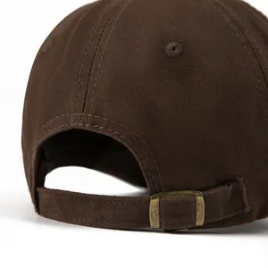 Rear view of dark brown cotton baseball cap showing adjustable bronze buckle and eyelets