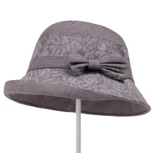 Detail of purple cotton sun hat with leaf embroidery and decorative side bow