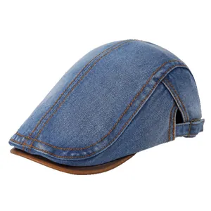 Vintage dark blue denim newsboy cap with brown leather brim and adjustable strap